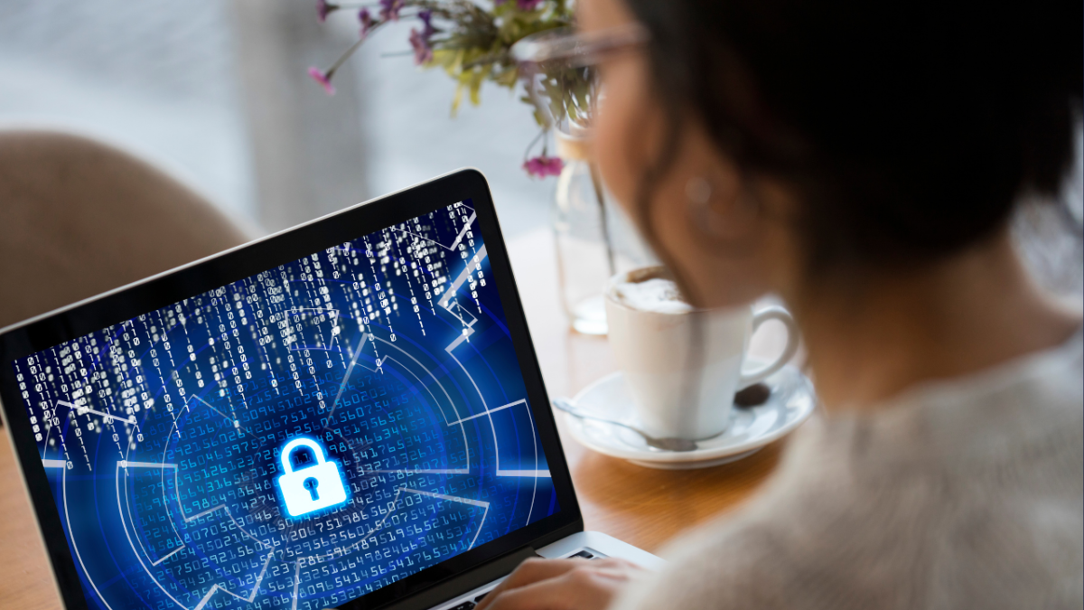 Brown haired girl looking at a laptop with a blue cyber background and lock icon