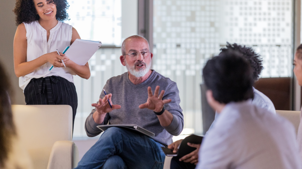 Man in office having a conversation with coworkers