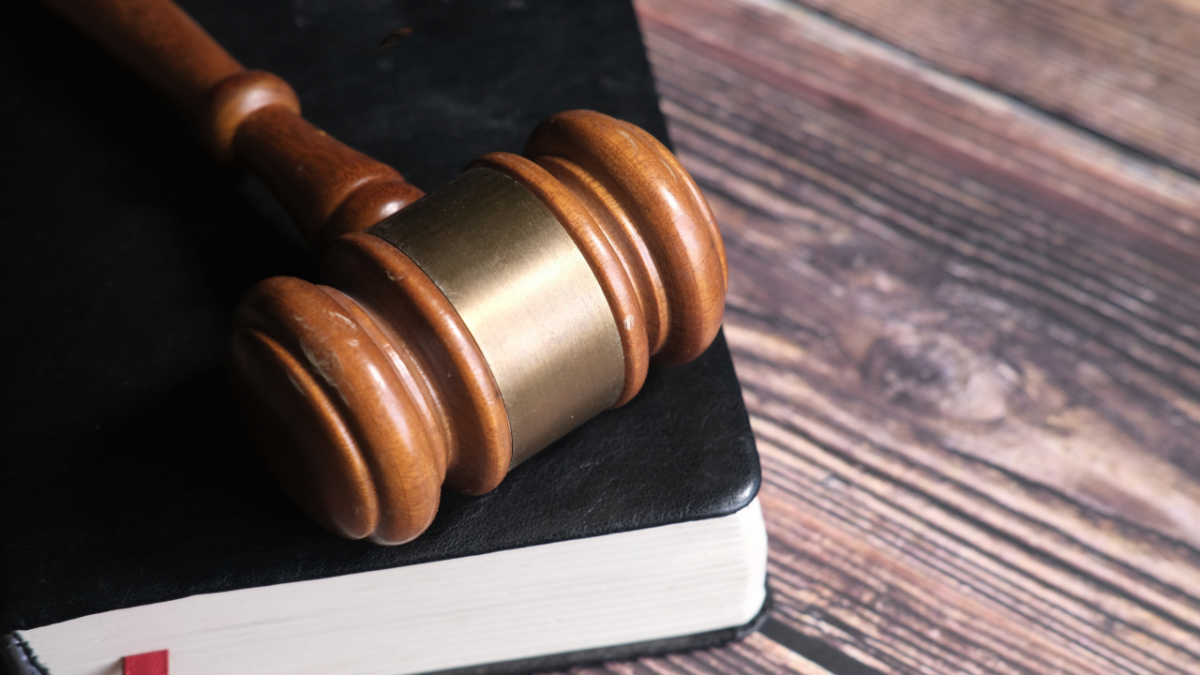 Gavel mallet resting on top of book