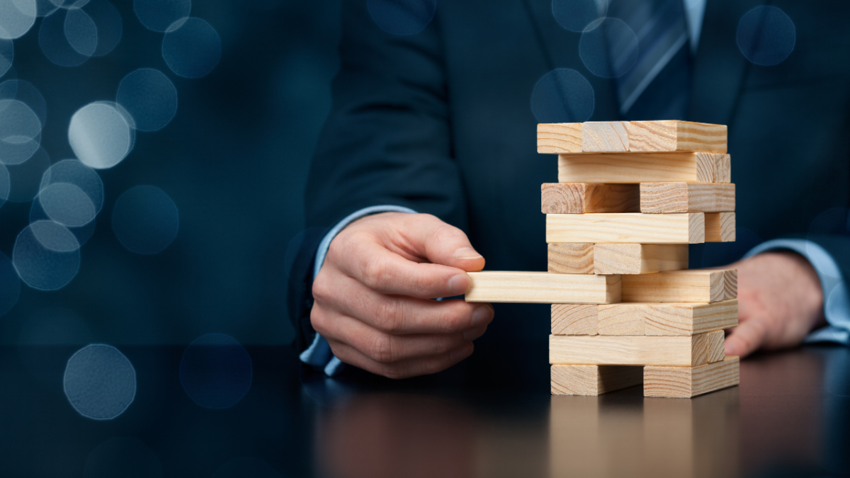 Business man playing jenga