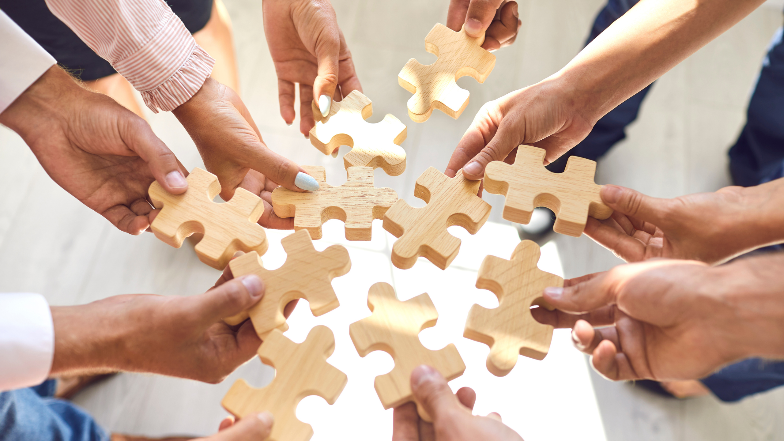 Group of people holding puzzle pieces