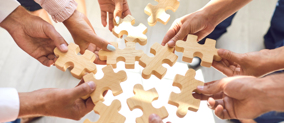 Group of people holding puzzle pieces